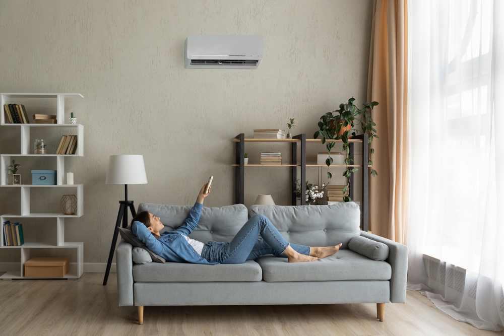 Glad,millennial,female,buyer,of,air,conditioner,relax,on,sofa